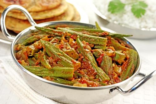 a pan filled with green beans and sauce at Sterling Balicha Udaipur in Udaipur