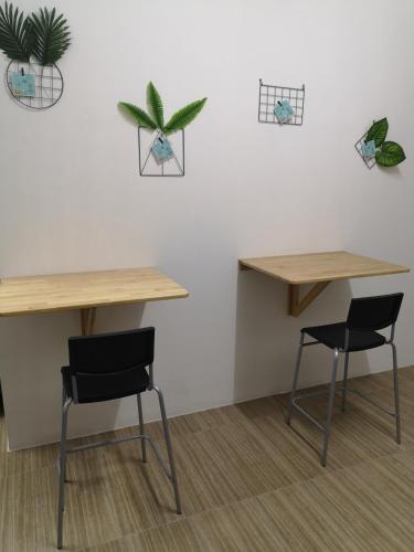 two tables and two chairs in a room at Homey Hostel, Ipoh Town in Ipoh
