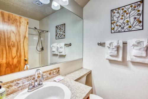 a bathroom with a sink and a toilet and a mirror at Beaches Inn | Puffins Place Cabana in Cannon Beach