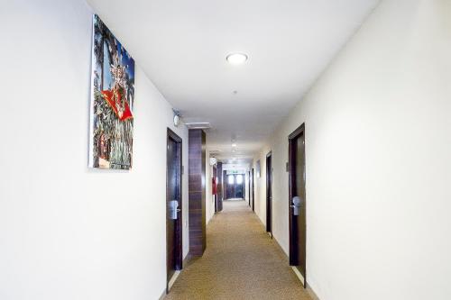 a hallway in a house with a painting on the wall at Hotel Grand Kartika in Samarinda