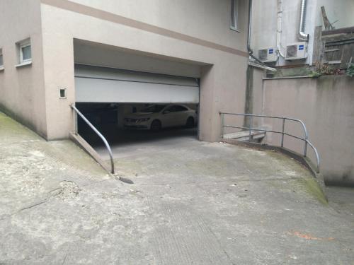 a garage with a car parked inside of it at Belimedik in Voždivac