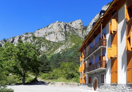 a building with a mountain in the background at Caserón Baruca in Bielsa