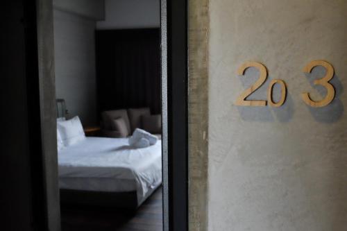 a room with a bed and a door with the number at CoffeeLoft in Taitung City