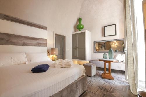a bedroom with a bed and a table in a room at AL CONSOLE LUXURY SUITE in Monopoli
