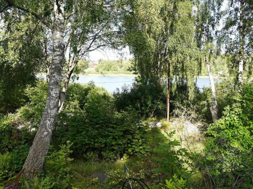 uma vista de um corpo de água através de árvores em 4 person holiday home in EKER em Ekerö