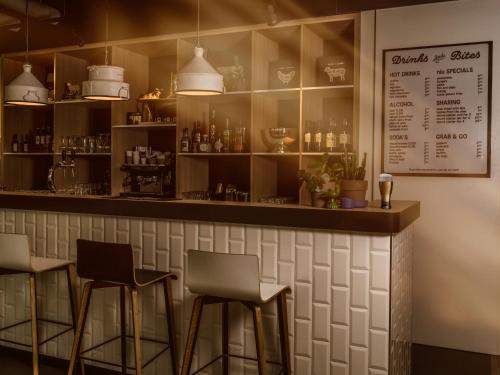 a kitchen with a bar and a table with drinks on it at the niu Dairy in Haarlem