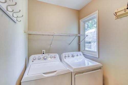 a laundry room with a washing machine and a window at St Andrews Common in Hilton Head Island