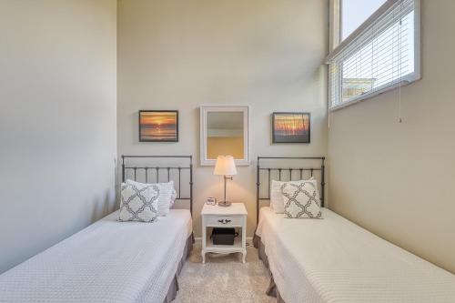 two beds in a room with two windows at St Andrews Common in Hilton Head Island