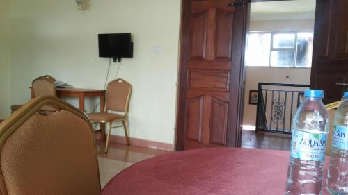 a bottle of water sitting on top of a table at RoseVilla Hotel in Arua