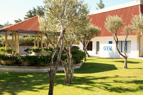 a group of trees in front of a building at Cyprotel Faliraki in Faliraki