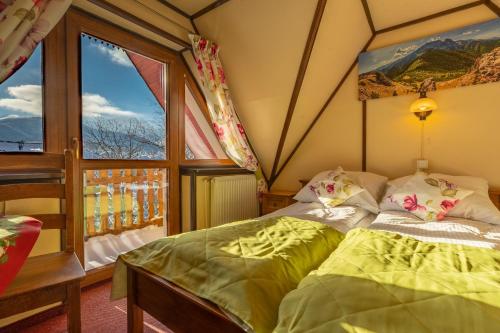 Кровать или кровати в номере Willa Kocham Tatry