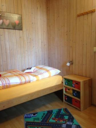 a small bedroom with two beds and a small cabinet at Ferienwohnung Ida in Kobbellück