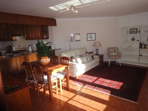 a living room with a couch and a table at Orchidea Terrace in Malveira da Serra