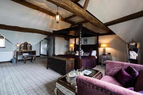 a bedroom with a bed and a couch and a table at Weston Hall in Stafford