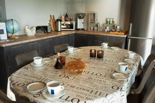 a table in a kitchen with a table cloth on it at Loa's Nest in Hella