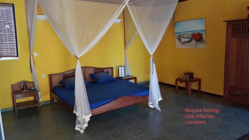 מיטה או מיטות בחדר ב-Villa Les Cocotiers