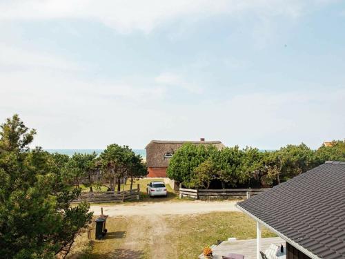 a house with a car parked in a driveway at 4 person holiday home in Slagelse in Slagelse