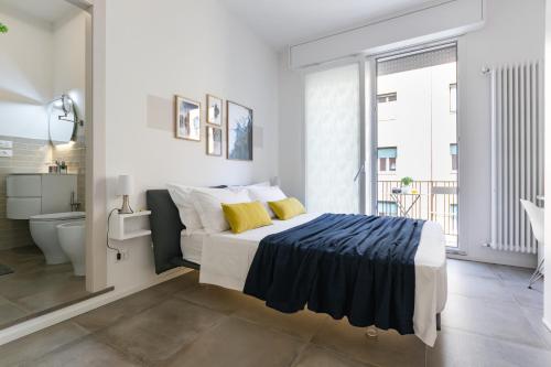 a bedroom with a large bed and a bathroom at Biasanòt Mini in Bologna