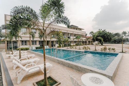 a hotel with a swimming pool and a resort at Aneeda Inn in Pantai Cenang