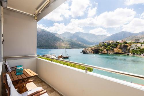 a balcony with a view of the water and mountains at Ocean Dream Apartment! in Balíon