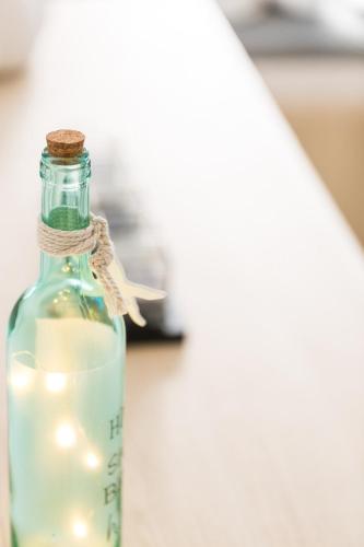 a bottle of milk with a candle in it at Ocean Dream Apartment! in Balíon