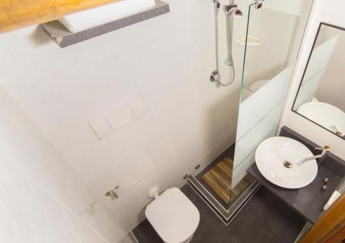a bathroom with a white sink and a mirror at Locanda Al Centrale in Caprino Veronese
