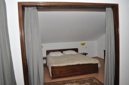 a bedroom with a bed in a room with a window at Hotel Alpin - 91 Bansko in Bansko