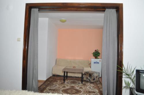 a living room with a couch and a table at Hotel Alpin - 91 Bansko in Bansko