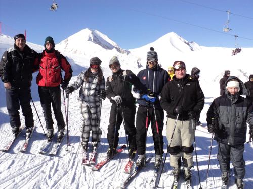 a group of people posing for a picture on a ski slope at Hotel Alpin - 91 Bansko in Bansko