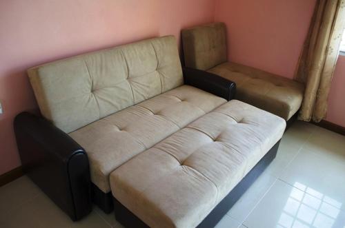 a living room with a large couch at Piarco Village Suites in Piarco