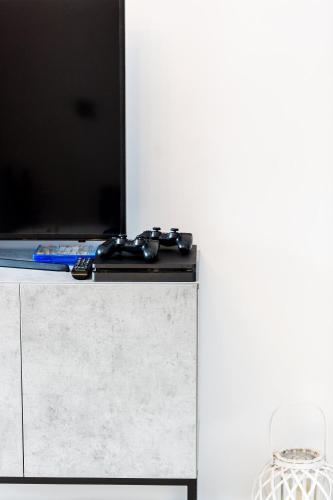 a table with a video game controller on top of it at Ocean Dream Apartment! in Balíon