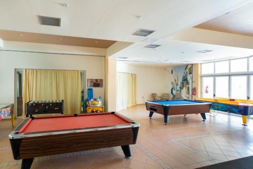 a living room with two pool tables in it at Sovereign Beach Hotel in Kardamaina