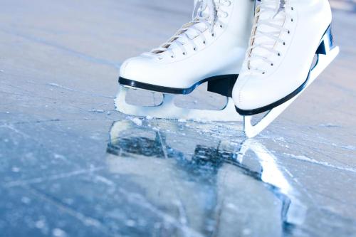 a person wearing white ice skates on the ice at MANNI village - lifestyle apartments in Mayrhofen