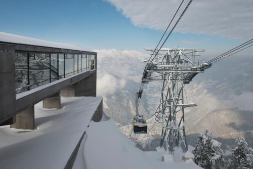 a ski lift at the top of a snow covered mountain at MANNI village - lifestyle apartments in Mayrhofen