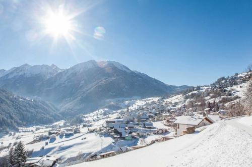 a ski resort in the mountains with snow on the ground at Ferienwohnung Krug in Wenns