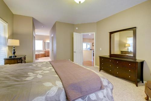 a bedroom with a large bed with a dresser and a mirror at Mule Deer Cabin (4-538) in Groveland