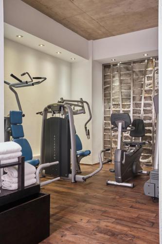 a gym with cardio equipment and treadmills at Hotel Monopol in Wrocław