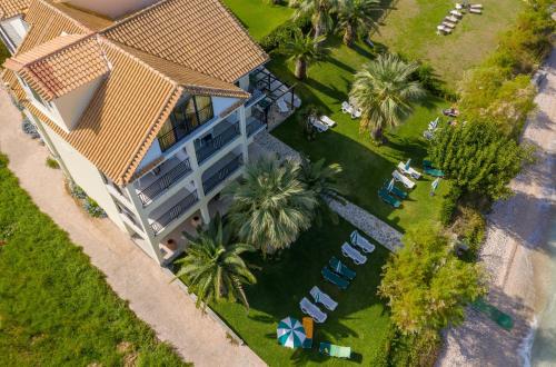 an overhead view of a house with a yard with chairs and palm trees at Sea View Hotel in Alykes