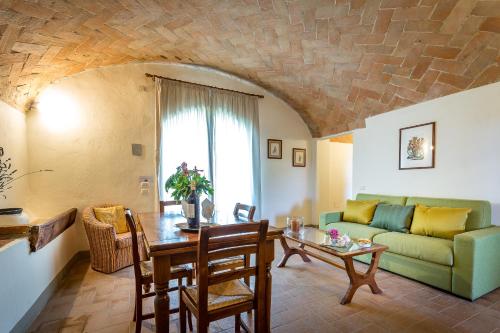 a living room with a couch and a table at Villa S.Andrea in San Casciano in Val di Pesa