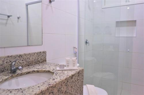a bathroom with a sink and a shower at Pousada Spadart in Salinópolis