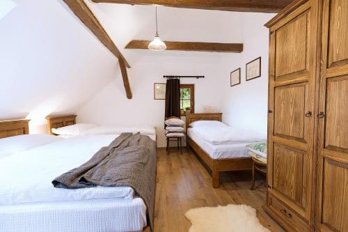 a bedroom with two beds and a dresser at CHATA MISTRIK in Donovaly
