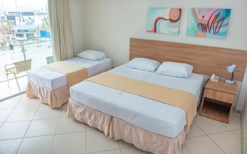 Postel nebo postele na pokoji v ubytování Hotel QualitySul