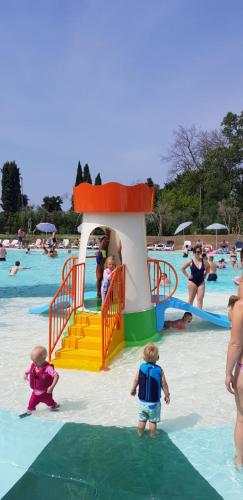 a small children's swimming pool with people playing in it at Camping Cisano - San Vito in Bardolino