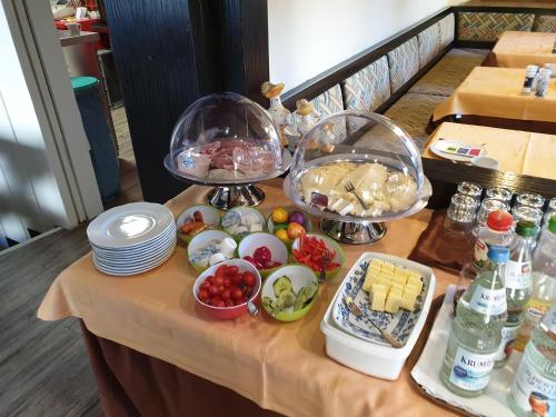 a table topped with plates and bowls of food at Hotel Brandl in Bad Wörishofen