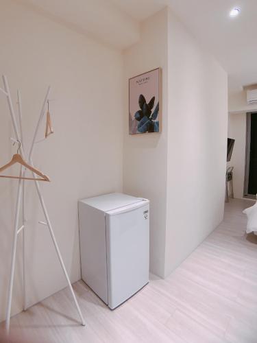 a washer and dryer in a white room at In Fengchia in Taichung