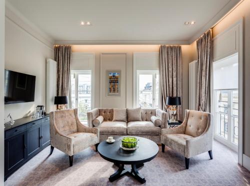 a living room with a couch and two chairs and a table at Hotel Bellotto in Warsaw
