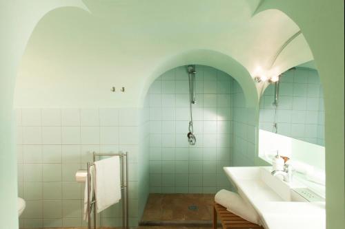 a bathroom with white tile walls and a sink at Agriturismo Casale Bonaparte in Cellere