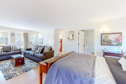 a bedroom with a bed and a living room at Seasons in Seal Cove in Seal Cove