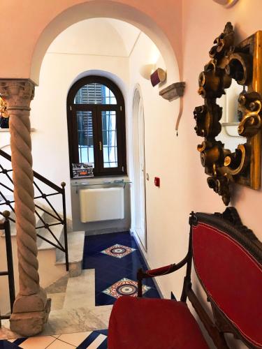 a hallway with an archway and a chair in a room at Hotel Croce Di Amalfi in Amalfi