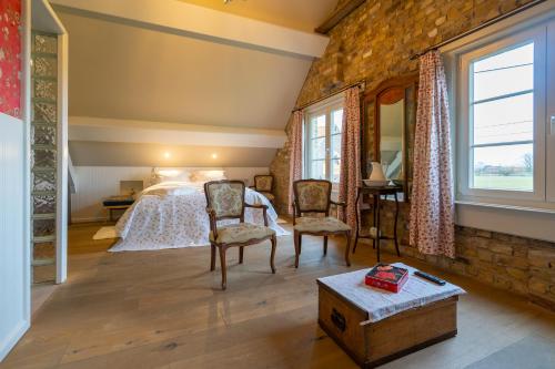 a bedroom with a bed and a brick wall at Gasthof Schraevenacker in Oostvleteren